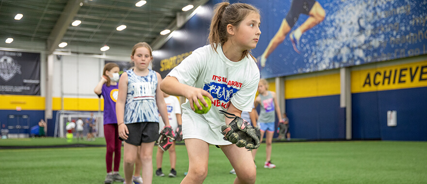 Youth softball athlete participating in the legends for kids softball clinic