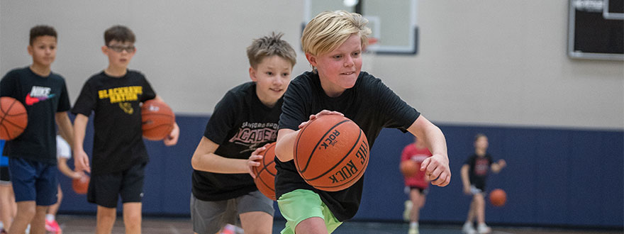 Young boy dribbling basketball