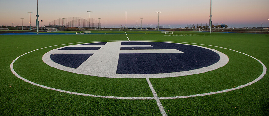 Image of the Loraine Cross at midfield of one of the artificial turf fields at the Sanford Crossing