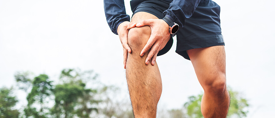 Man grabbing his knee in pain
