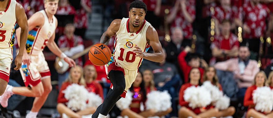 Nebraska guard Jamarques Lawrence (#10) dribbles the ball on a fast break