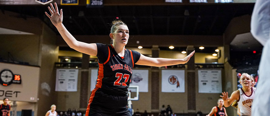 Women's basketball player defends inbounds pass