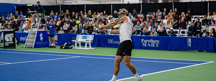 Pro tennis player swinging racket