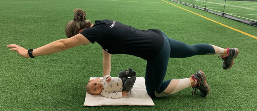 Woman doing core exercise with baby