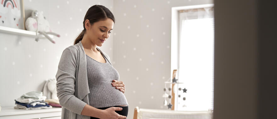 Women smiling at pregnant stomache