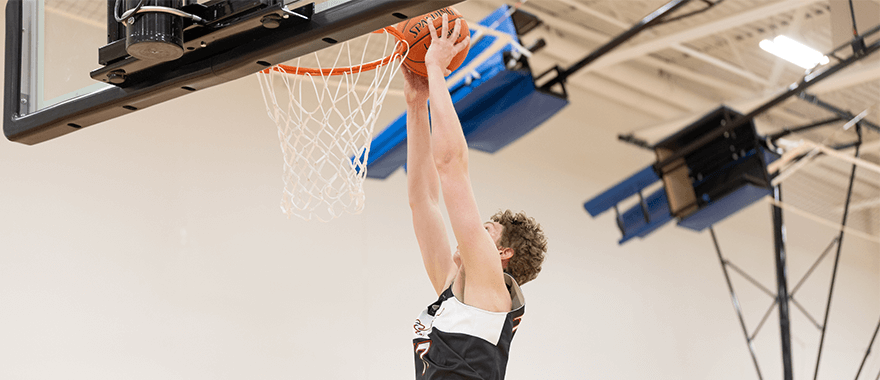 Sanford Sports Academy athlete dunking a basketball