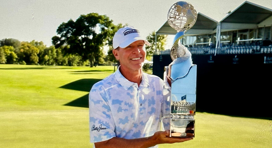 Photo of Steve Stricker holding the Sanford International trophy as the 2023 champion