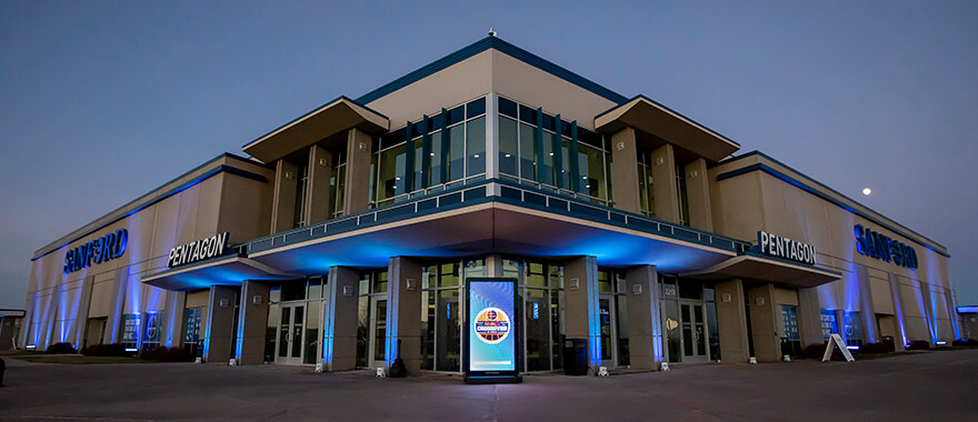 Image of the exterior of the Sanford Pentagon illuminated by glorious blue uplighting