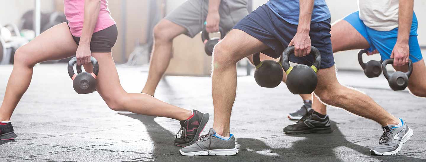 adults lunging with weights