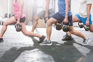 adults lunging with weights