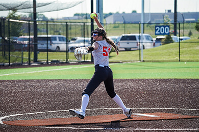 Sanford Sports Academy Softball player pitching at the Sanford Diamonds