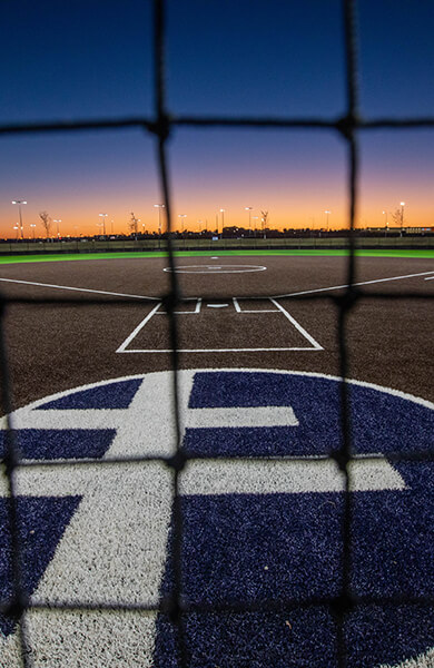 Picture behind home plate of a softball field at the Sanford Diamonds