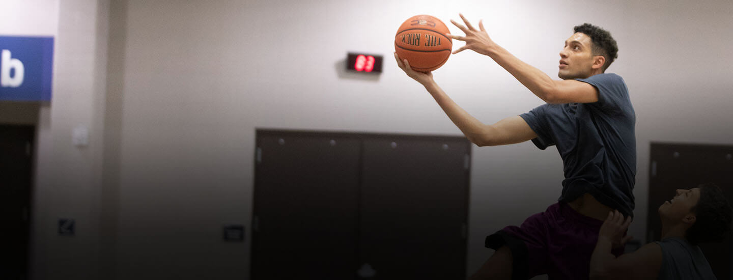 Basketball player driving for a layup