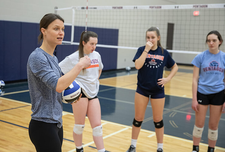 Volleyball player/coach, Courtney Thompson, instructs athletes during a volleyball camp at the Sanford Pentagon