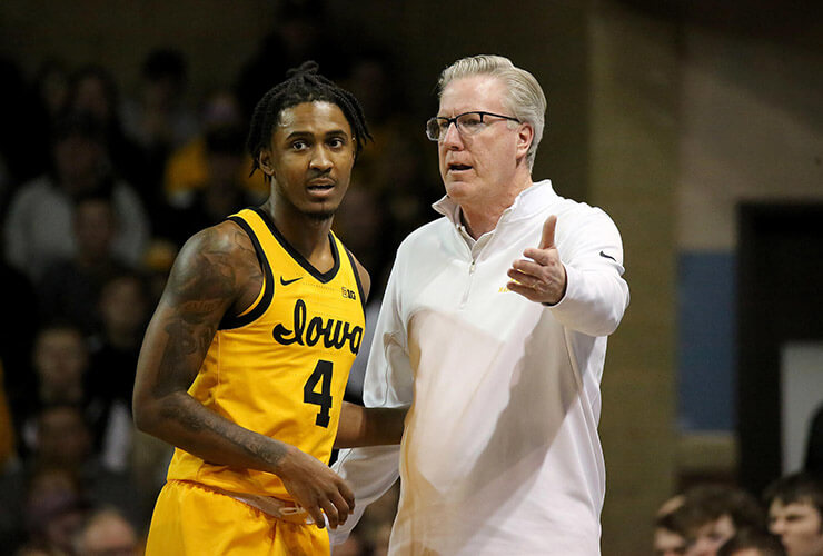 Iowa Hawkeye basketball coach Fran McCaffery talking to Guard Ahron Ulis during their game against Utah State at the Sanford Pentagon