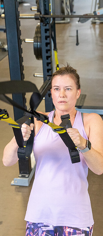 Athlete using TRX bands during a strength training session with Sanford Sports Performance