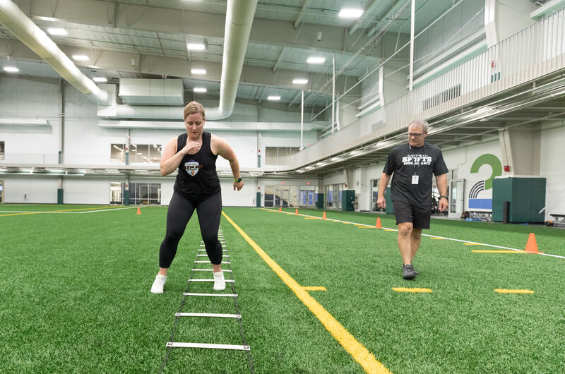 Women doing ladders with coach