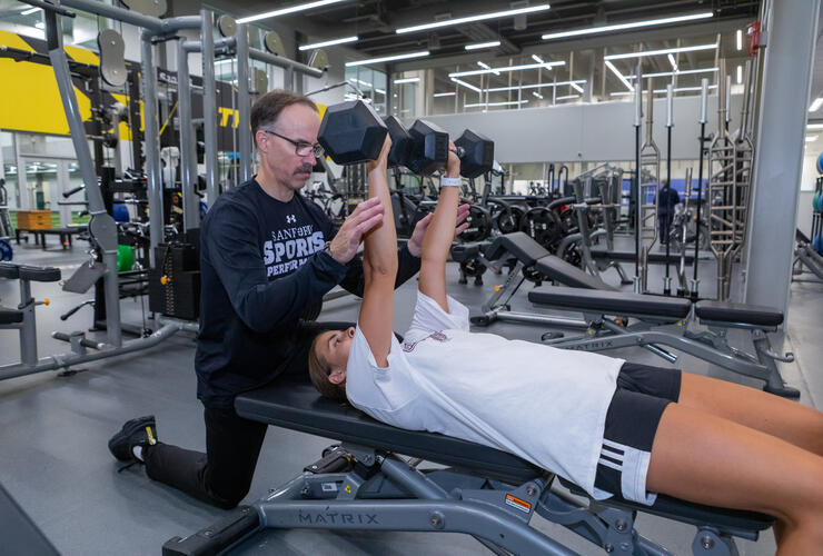 Athlete strength training with Instructor