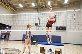 volleyball player spiking ball in practice