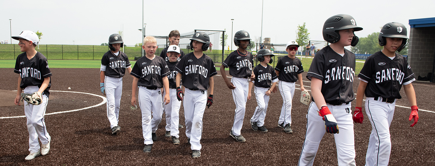 team in black jerseys all walking off the field 