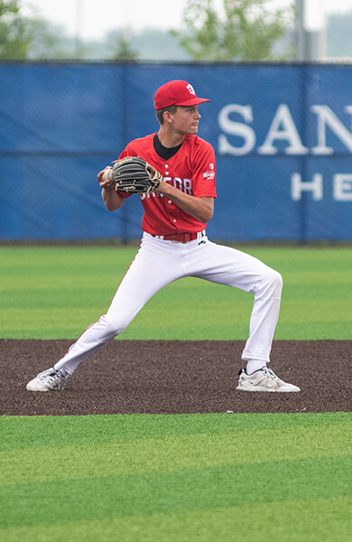 sanford sports baseball player fielding and getting to ready to throw a baseball during a game