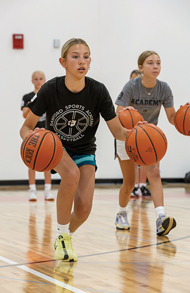 young boy dribbling basketball
