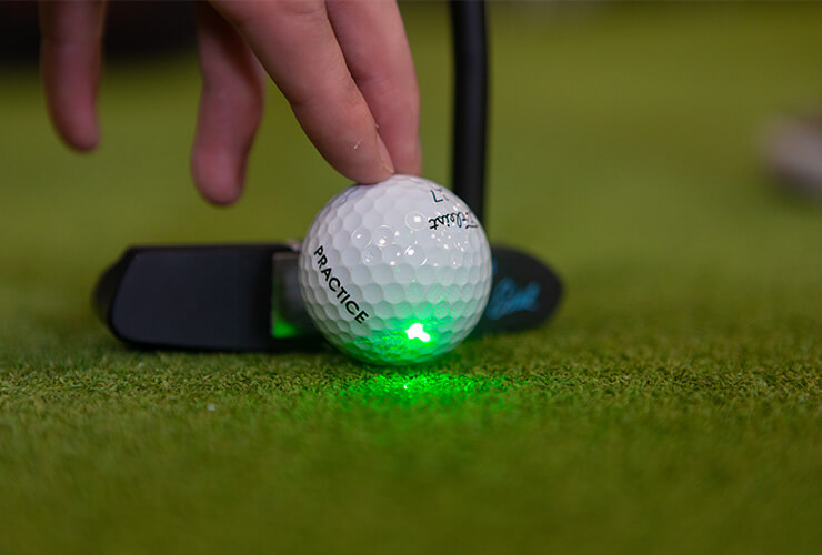 golf ball with putter and laser on ball