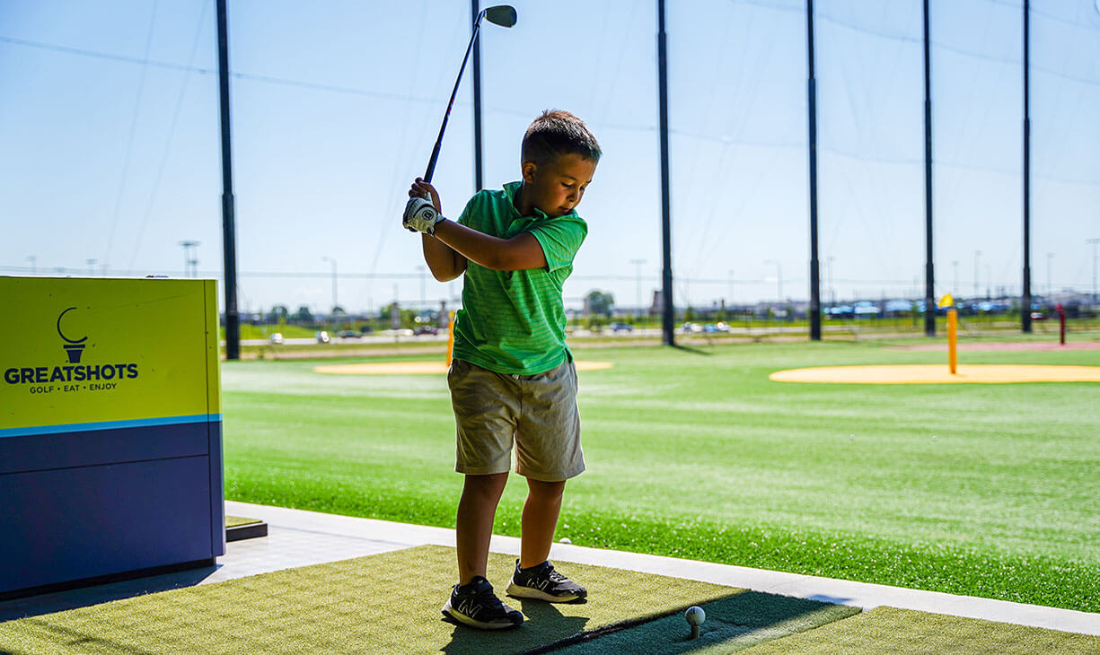 young kid winding up to hit a ball at Great Shots