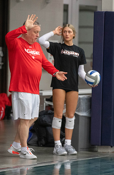 volleyball player and coach practicing a serve